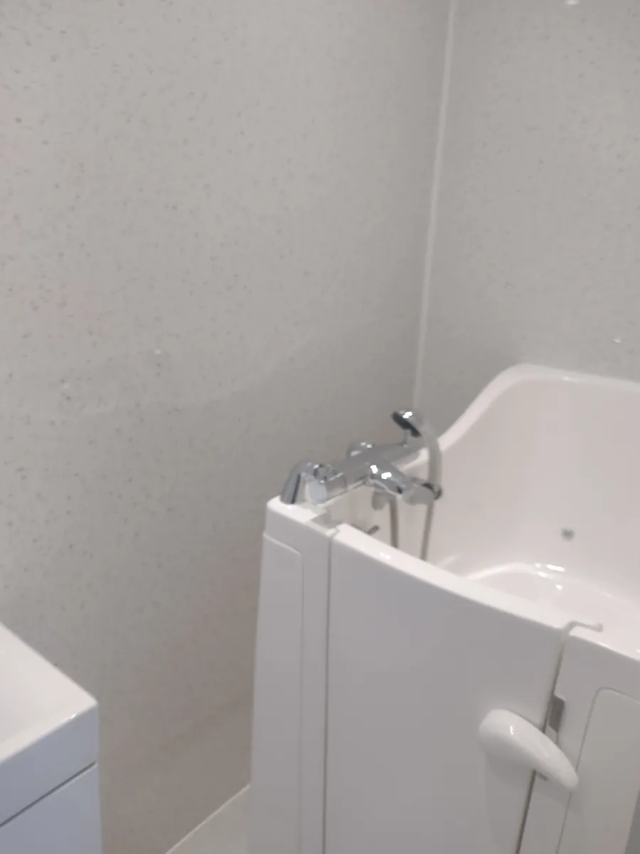 Bathroom with a walk-in bath and wall panelling